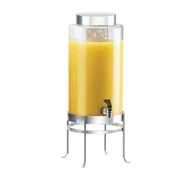 A Cal-Mil glass beverage dispenser with a yellow liquid inside.