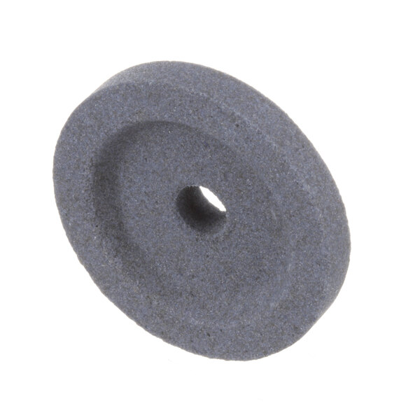 A grey circular Berkel sharp/debur stone with a hole in the middle.