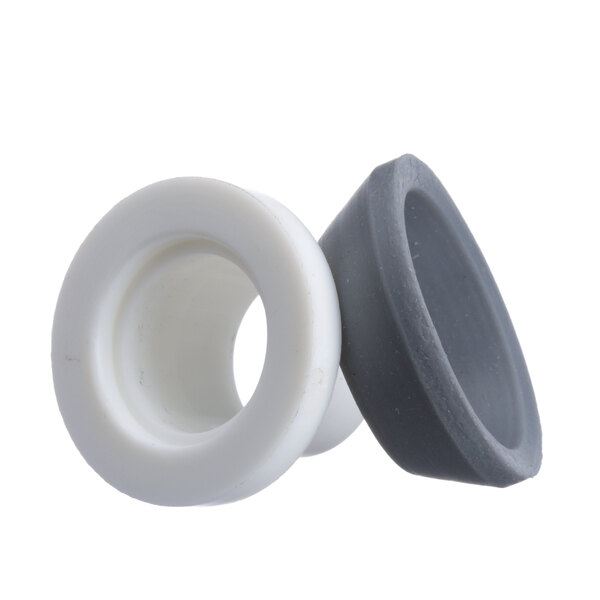 A white and gray rubber rear seal with a hole in it.