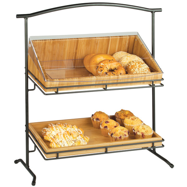 A Cal-Mil Madera two tier stand holding trays of pastries and muffins.