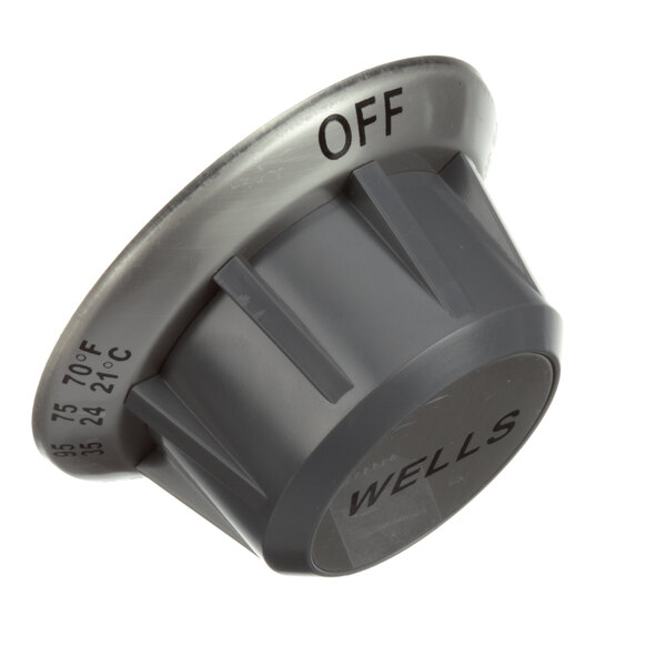 A grey plastic Wells knob with black text that says "off"