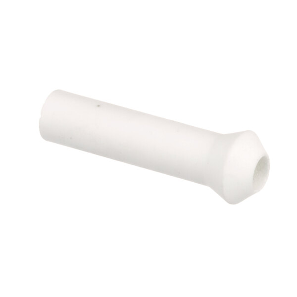 A close-up of a white porcelain tube with a hole.