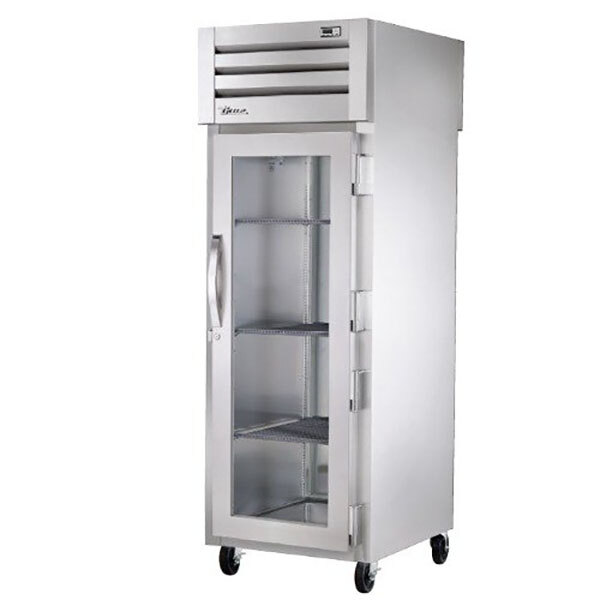 A True Spec Series pass-through refrigerator with glass doors and a metal cabinet.
