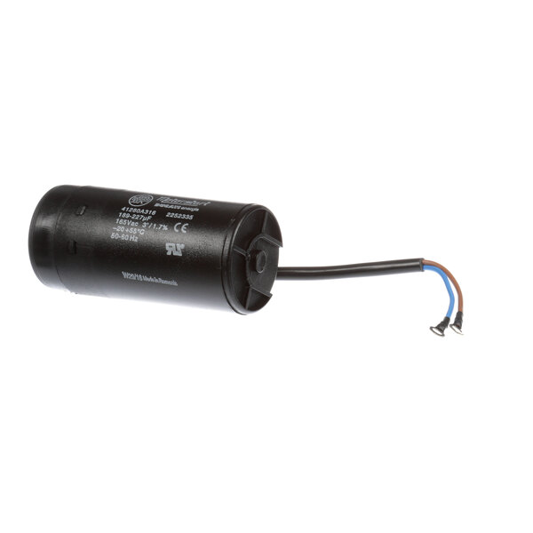 A black round Glastender capacitor with wires.