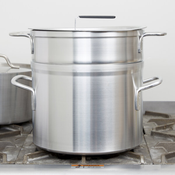 A Vollrath Wear-Ever aluminum double boiler set on a stove.