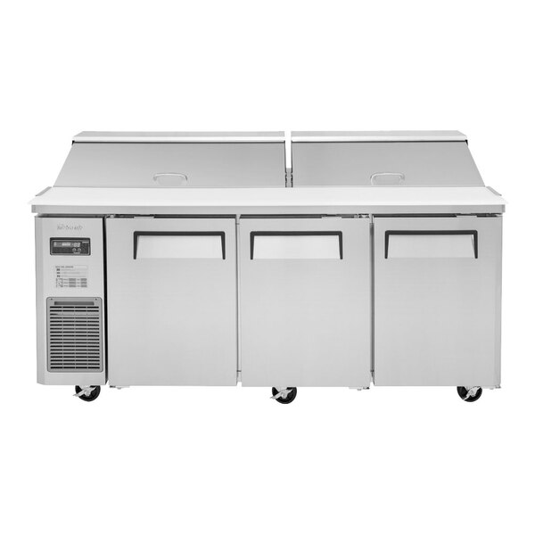 A Turbo Air 3 door refrigerated sandwich prep table on wheels.