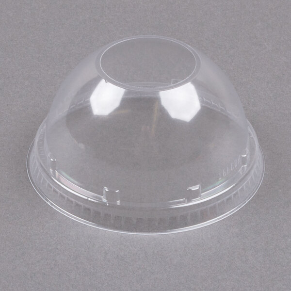 A clear plastic container with a clear dome lid with a hole in it.