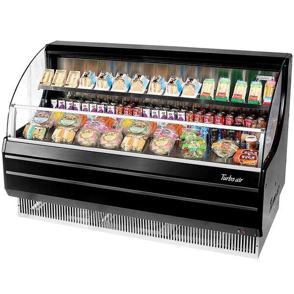 A Turbo Air black horizontal air curtain display case on a deli counter with food inside.