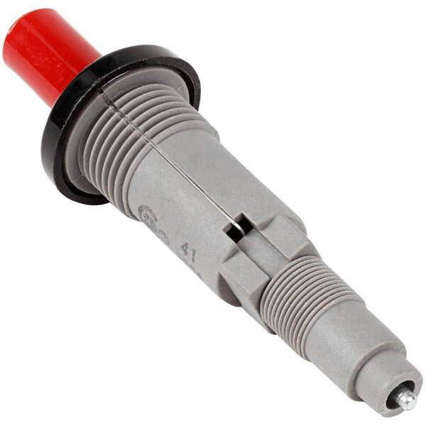 A grey and red spark plug with a red plastic and metal connector.