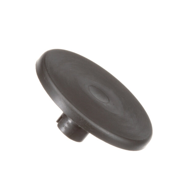 A close up of a black plastic Berkel spacer plug with a round center.