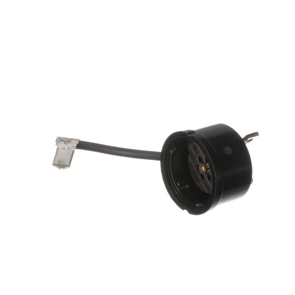 A black electrical connector with a wire attached to a black round device.