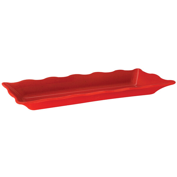 A red rectangular melamine tray with wavy edges.