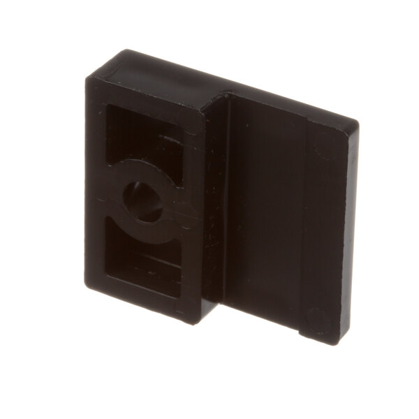 A close-up of a black plastic square with a hole in it.