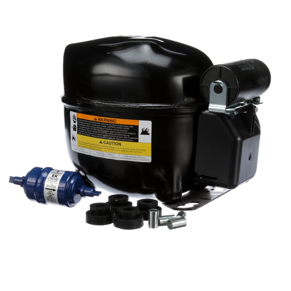 An Ice-O-Matic black compressor with a blue and black cap.