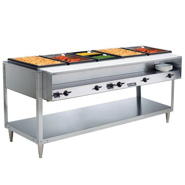 A Vollrath ServeWell electric hot food table with food trays on a table.