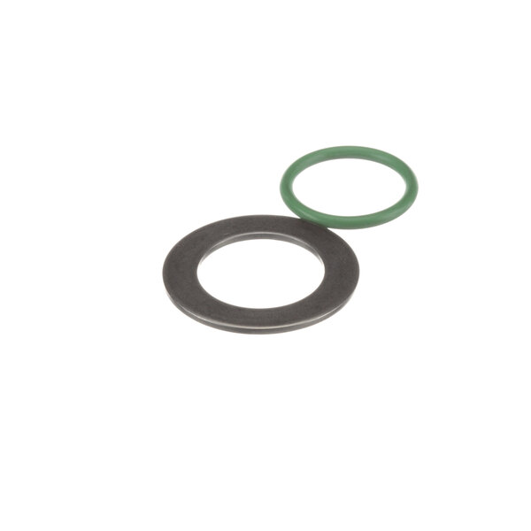 A close-up of a green and black gasket with a metal ring.