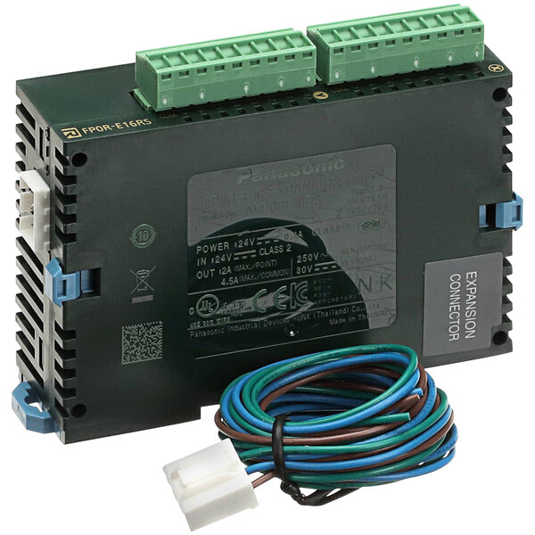 A black electronic device with green and blue wires attached to a green and blue plastic container.