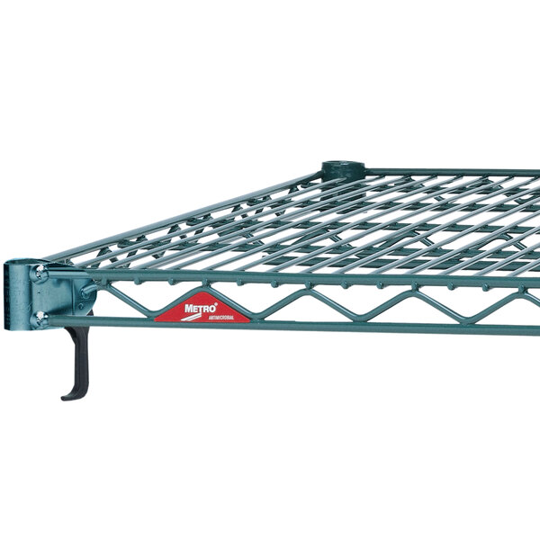 A Metroseal wire shelf on a Metro metal rack with a red label.