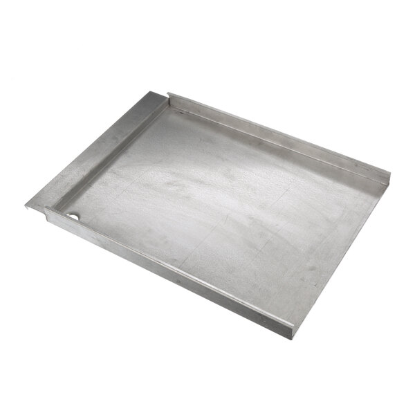 A metal tray with a handle and a hole in the middle.