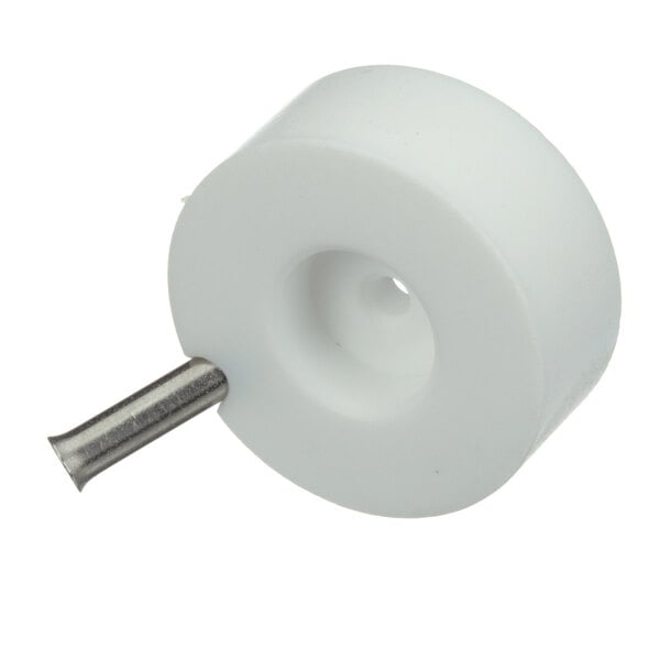 A white plastic wheel with a metal pin and a white circle with a hole in it.