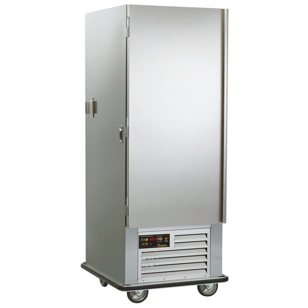 A Traulsen stainless steel reach-in refrigerator with a solid door on wheels.