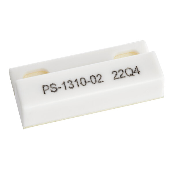 A white rectangular plastic plate with black text that says "Scotsman PS-10-0-2-2"
