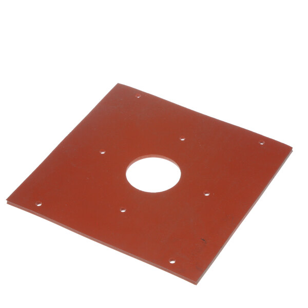 A red plastic gasket with holes on a white surface.