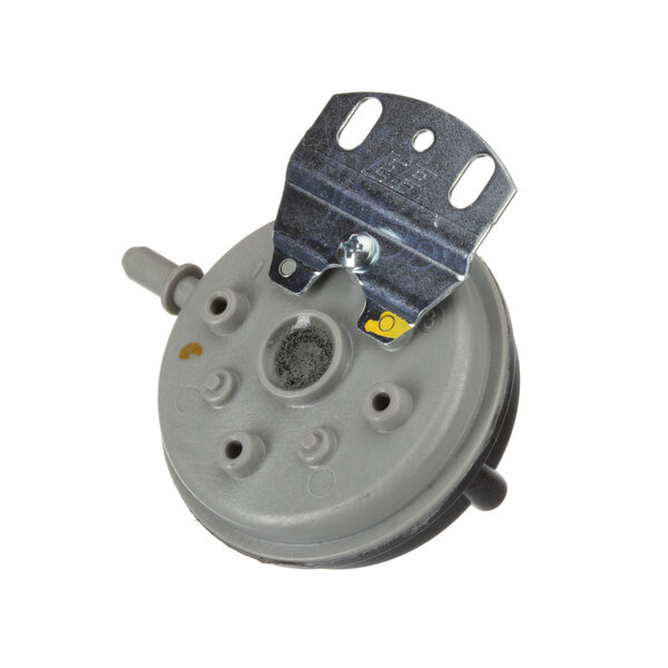 A grey round device with a metal bracket.