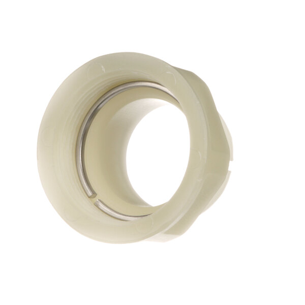 A close-up of a white plastic circular nut.