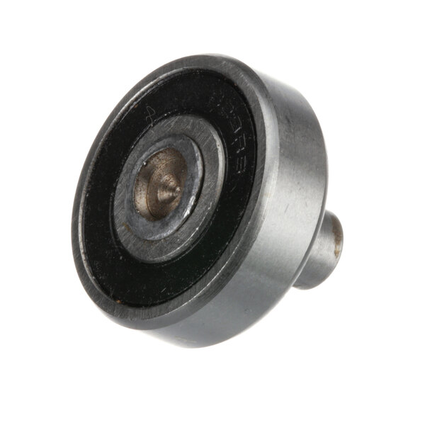 A round metal Berkel lower stud and roller with a black circle in the center.