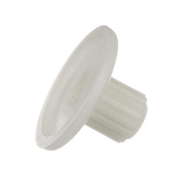 A close-up of a white plastic knob with a white circle on it.
