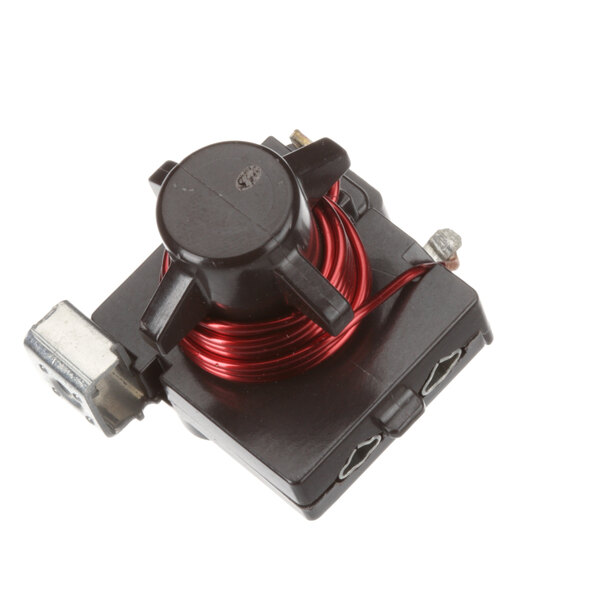 A black electrical device with a red wire.