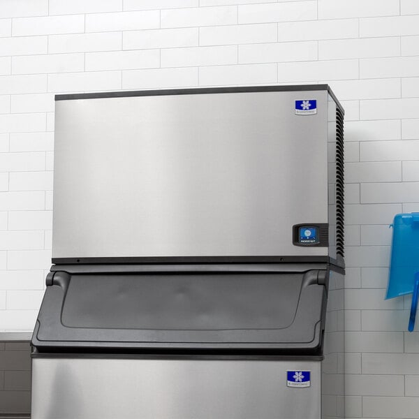 A large stainless steel Manitowoc Indigo NXT air cooled ice machine.