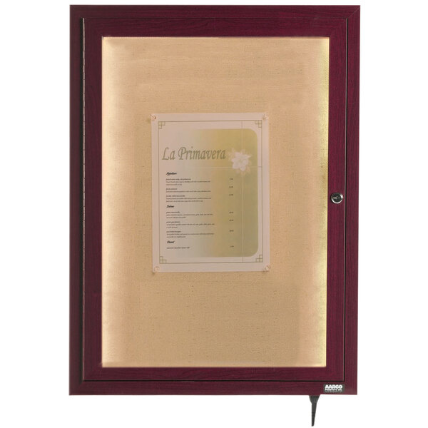 An Aarco cherry finish framed glass cabinet with a menu inside.