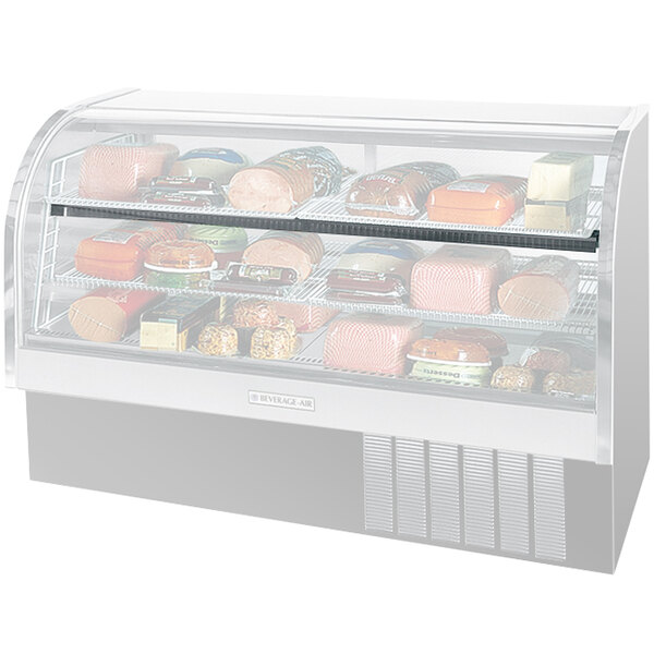 A Beverage-Air shelf light installed in a refrigerated display case with food on shelves.