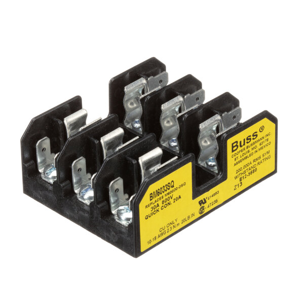 A close-up of a black and yellow Champion fuse block with four terminals.