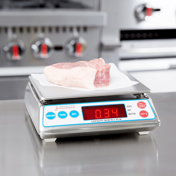 A Cardinal Detecto digital scale with meat on it.