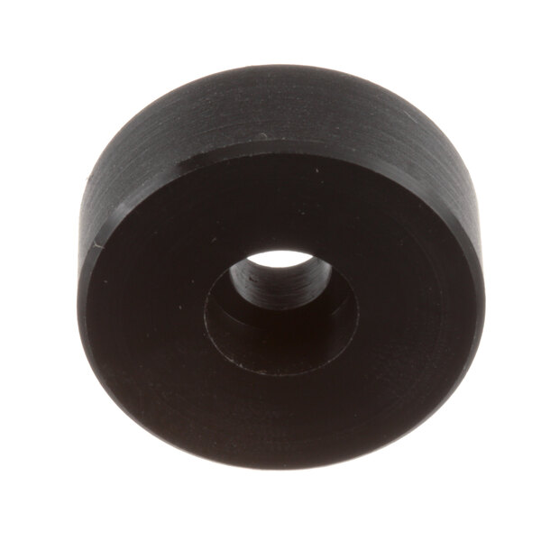 A black round object with a hole in the middle.