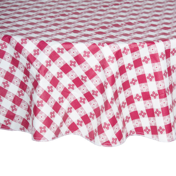 A burgundy gingham vinyl table cover with a red and white checkered pattern on a table.