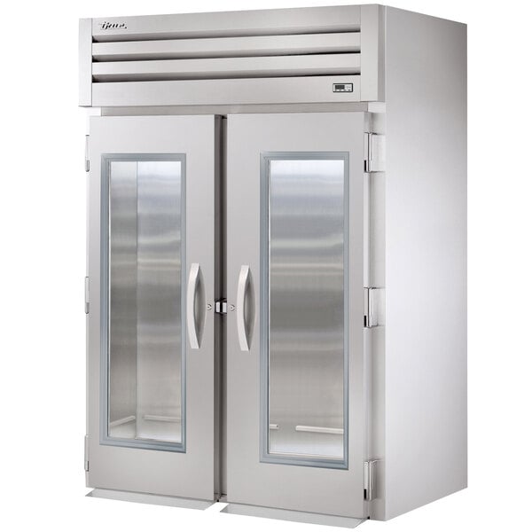 A True Spec Series glass door roll-in refrigerator with a silver door.
