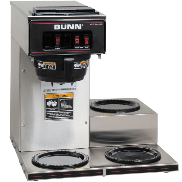 A Bunn VP17-3 coffee brewer on a counter with two cups of coffee.