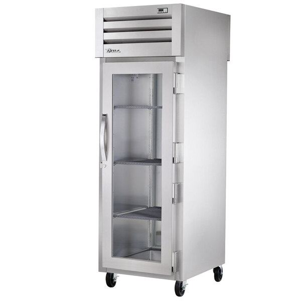 A True stainless steel pass-through refrigerator with a glass door.