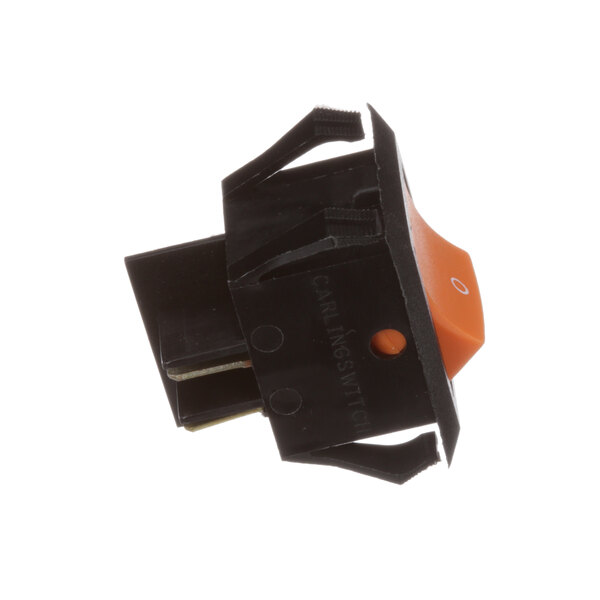 A close-up of a black and orange Duke lighted switch.