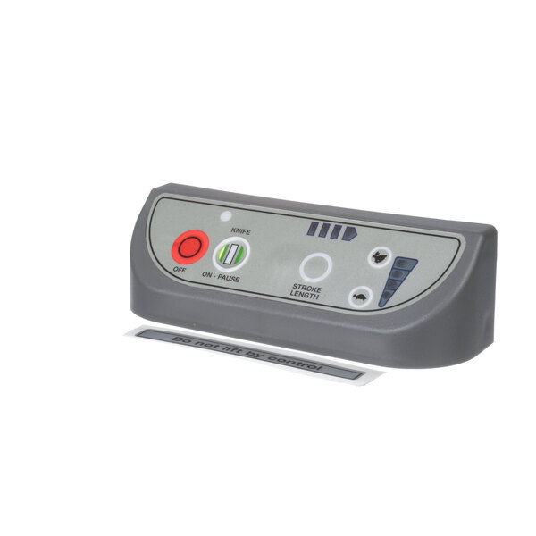 A grey control panel with a red button.