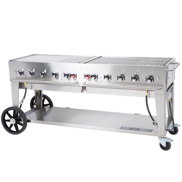 A large stainless steel Crown Verity portable outdoor BBQ grill with four burners.