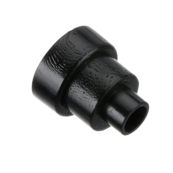 A close-up of a black plastic pipe fitting for a Wilbur Curtis coffee machine.