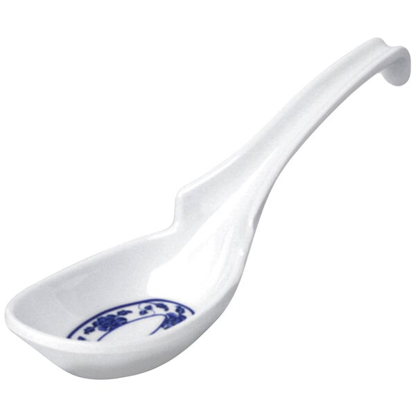 A white spoon with blue Lotus design on the handle.