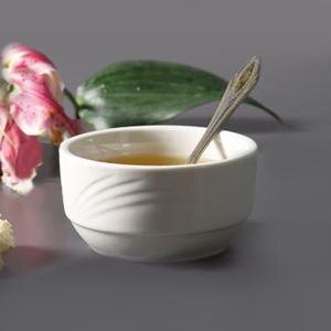 A CAC white porcelain bouillon bowl filled with liquid with a spoon in it.