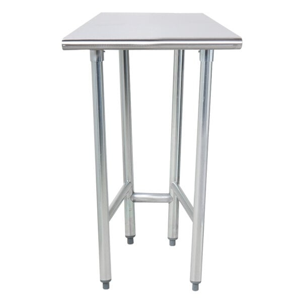An Advance Tabco stainless steel work table with an open base on legs with a white background.