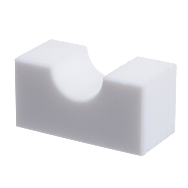 A white plastic block with a hole.